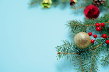 Christmas composition of Christmas toys, candy and spruce branches on a blue background. space for text. keyboard layout