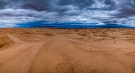 Storm clouds over sand dunes in the desert