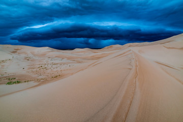 Storm clouds over sand dunes in the desert