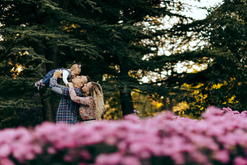 Fototapeta premium Happy family father, mother and child daughter outdoor enjoying sunset - Image