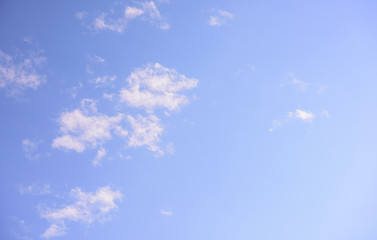Beautiful pastel colored clouds at sunset isolated against blue skies
