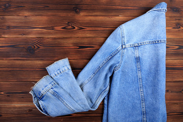blue denim jean jacket  on wooden background.