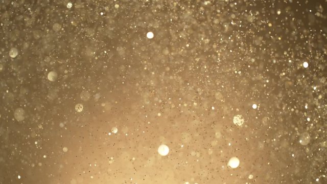 Golden Glitter Background in Super Slow Motion at 1000fps. Shooted with High Speed Cinema Camera in 4K Resolution.