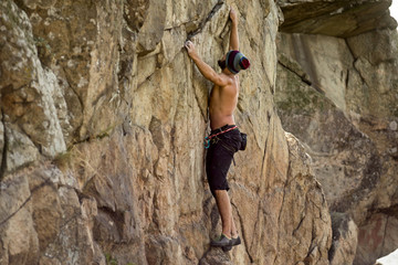 Man cliff climber is climbing a rock.