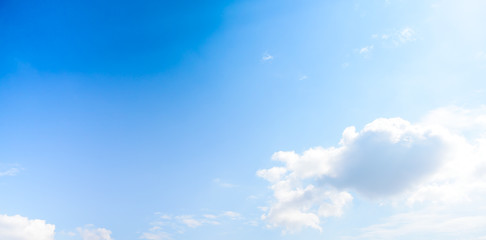 Beautiful puffy clouds with sun beams against blue skies.  