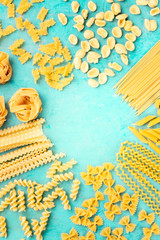 Italian pasta, flat lay design template with copyspace, overhead shot on a blue background