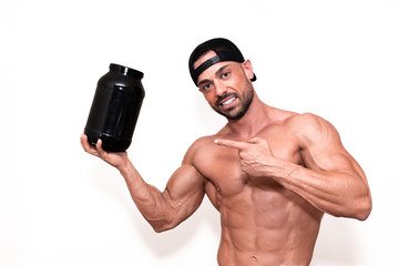 Fototapeta na wymiar Fitnes model boy pointing a protein container in his hand