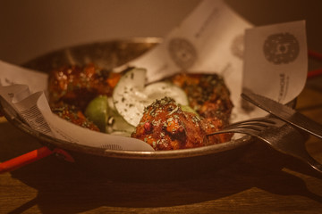 SAMBAL WINGS Grilled chicken wings doused in sambal sauce garnished with cucumber and a squeeze of calamansi