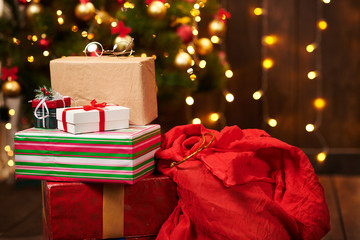 Close-up of gift boxes. Christmas lights and decoration on dark background - Happy Holidays concept