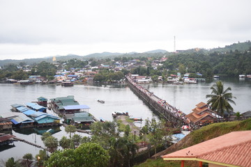 KANCHANABURI, THAILAND - October 5: unidentified woman taking a photo at the old wooden Mon Bridge in Sangkhla Buri on October 5, 2019 in Kanchanaburi, Thailand