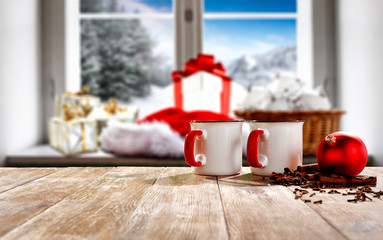 Fototapeta premium Christmas decorations in bright colors with blurred snowy winter outside the window background.