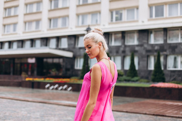 Fashionable beautiful young blondie woman posing in trendy fashionable costume in pink colors. Beauty, fashuon, modeling concept