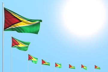 wonderful any holiday flag 3d illustration. - many Guyana flags placed diagonal on blue sky with space for text