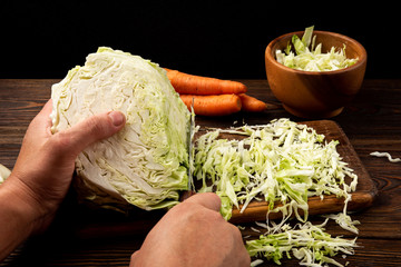 Fresh cabbage on dark wooden background.