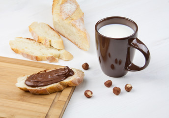 Chocolate paste with bread and milk.