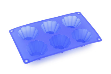 Silicone form for baking cupcakes on white background.