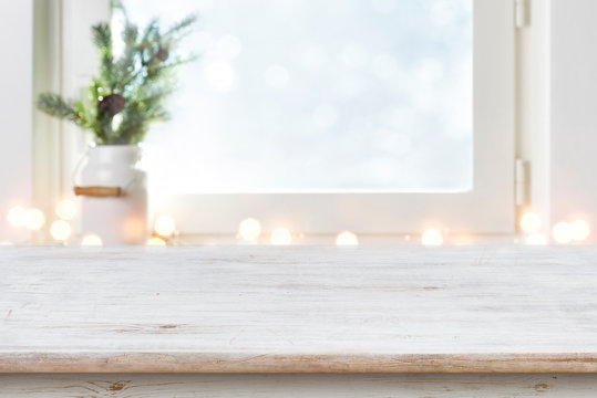 Blurred winter holiday background with vintage wooden table in front