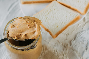 thick peanut butter in a jar close-up. Healthy eating.