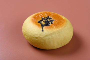 side view red bean paste cake on a brown background