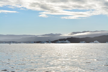 Disko Bay, Greenland - July - boat trip in the morning over the arctic sea - cold and fresh air and big beautiful icebergs, quiet moments in a wonderful nature	