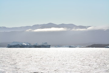 Disko Bay, Greenland - July - boat trip in the morning over the arctic sea - cold and fresh air and big beautiful icebergs, quiet moments in a wonderful nature	