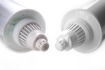 Used Dirty and New Clean Replacement Pitcher Water Filters on White Background. Used Filter Has Green and Brown Mold Spots. Hygiene, Health Concept.