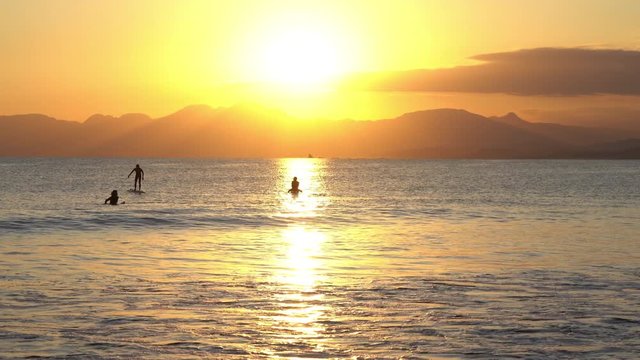 Surfers in the evening 