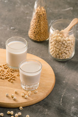 Glasses of lotus seed milk and soy milk on table.