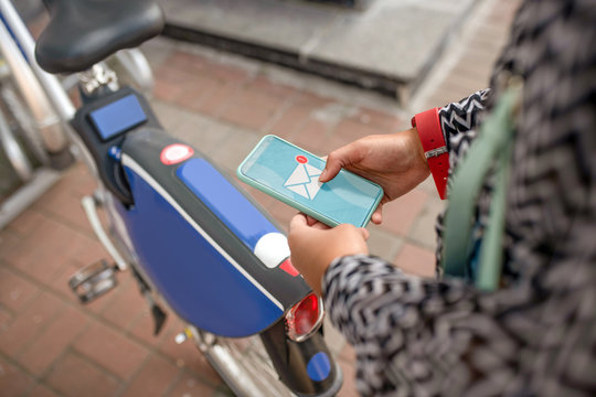 Close up of young woman checking her e-mail on smartphone