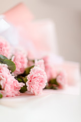 Pink bouquet of carnation flowers on the desk