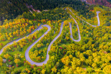 Aerial view of winding road on mountain in Autumn