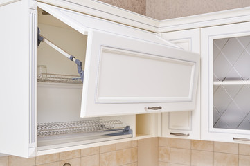 dish drying rack in Hanging cabinets with milling and cornices in white classic kitchen