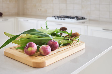Wooden Board with vegetables and fruits in the kitchen