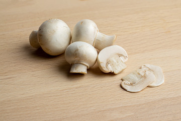 Fresh champignon mushrooms on wood