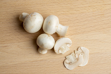 Fresh champignon mushrooms on wood