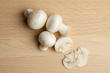 Fresh champignon mushrooms on wood