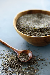 Chia seeds in old wooden bowl