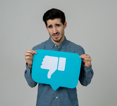 Beautiful Sad young man holding dislike social media notification icon