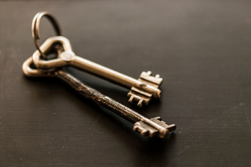 bunch of old keys on wooden background