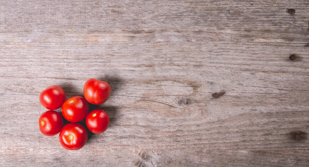 ripe tomatoes on wooden board in studio