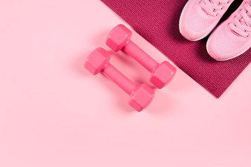 Flat lay shot of sneakers on pink background.