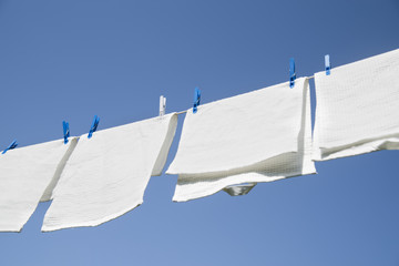 White laundry hanging on a string outdoors