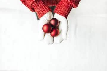 Christmas / New year / xmas composition. Young woman in red knitted sweater and white mittens...