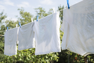 White laundry hanging on a string outdoors