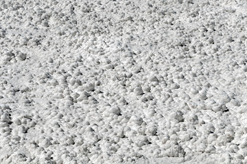 Salt crystals on the salty surface of desert close up. Natural background with copy space