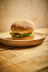 delicious classic burger on wooden board and black background