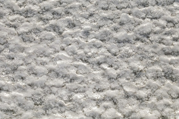 Salt crystals on the salty surface of desert close up. Natural background with copy space