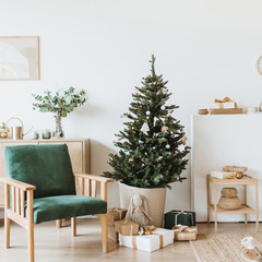 Modern interior design living room with Christmas / New Year decorations, toys, gifts, fir tree. Winter holidays composition. © Floral Deco