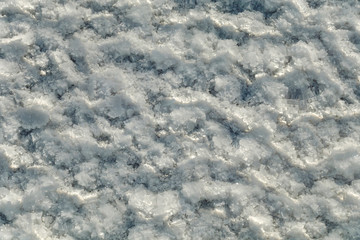 Salt crystals on the salty surface of desert close up. Natural background with copy space