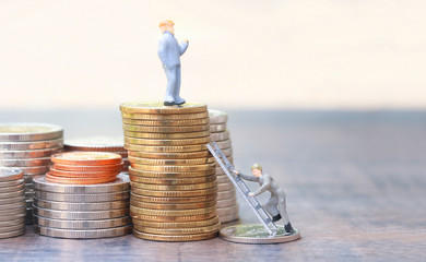 Pile of coins. miniature man climbing up by ladder to the higher to be the rich. , Inequality the gap between the rich and poor. .